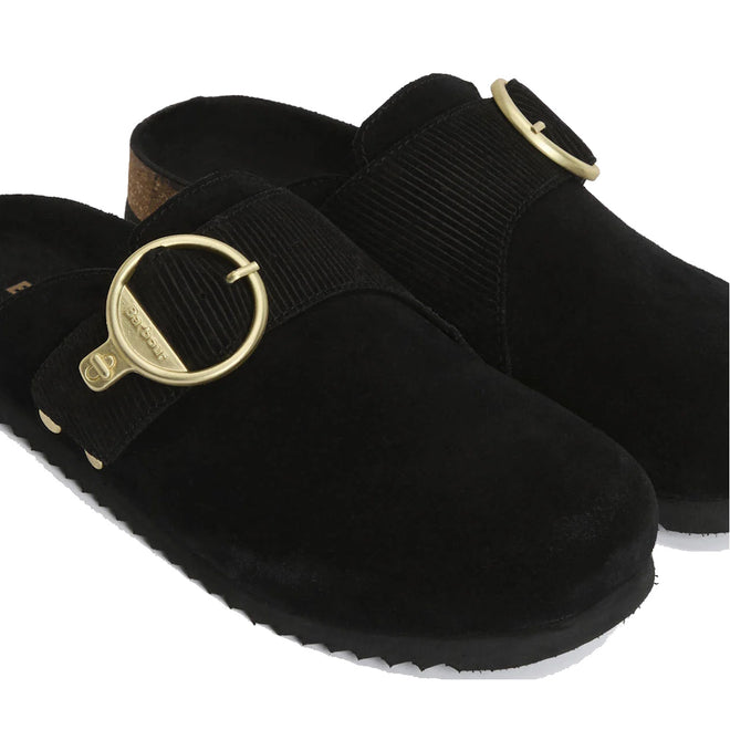 The Barbour Kyra Womens Closed Toe Clog Sandal in black suede features a slip-on design with a cork insole, wide black strap, and a bold round gold buckle across the top., 5063669169339,
5063669169346,
5063669169353,
5063669169360,
5063669169377,, 5063669169339, 5063669169346, 5063669169353, 5063669169360, 5063669169377, 51856
