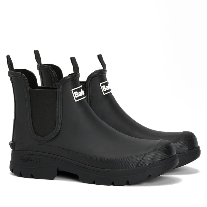 The Barbour Nimbus Black Chelsea Wellingtons Men’s Rainboot features a waterproof ankle boot design with elastic side panels, pull tabs, and thick ridged soles, displayed against a white background.