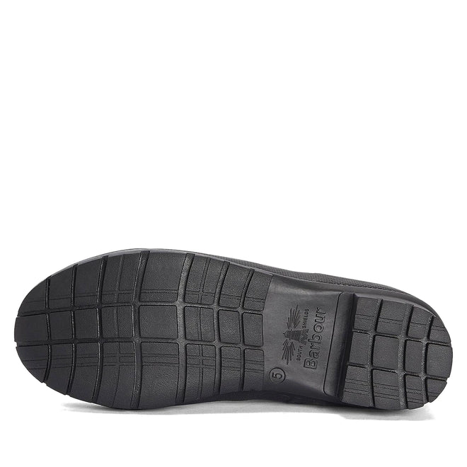 The image shows the black rubber sole of the Barbour Abbey Black Tall Welly Women's Rainboot, featuring a crisscross tread and central Barbour logo, emphasizing the durability of these classic women's rain boots., 51350, 192569962865, 192569963022, 192569963145, 51354, 51355