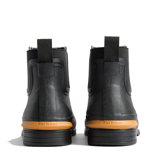 A pair of Barbour Abbeyfield Packable Ankle Wellingtons in black, shown from the back with tan soles, pull tabs, and Barbour branding embossed above the heels—these lightweight ankle wellingtons are ideal as stylish and practical festival boots., 54323, 5063669380451, 5063669380468, 5063669380475, 5063669380482, 5063669380499, 54329