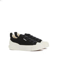 Barbour Womens Stanhope Canvas Trainer in Black features white rubber soles and toe caps, black laces, and a small branded side tag. Displayed on a plain white background.