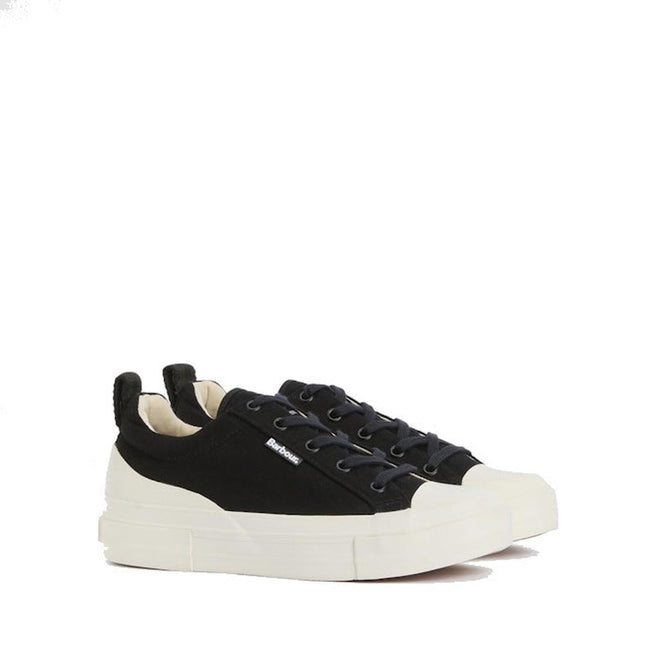 Barbour Womens Stanhope Canvas Trainer in Black features white rubber soles and toe caps, black laces, and a small branded side tag. Displayed on a plain white background.