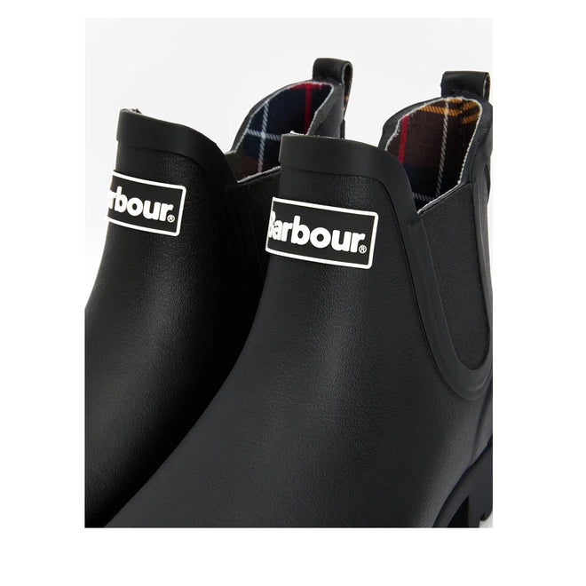 Close-up of two Barbour Wilton Black Chelsea Wellingtons Womens Rainboots with elastic side panels, front Barbour logo, and an interior tartan lining in red, blue, yellow, and white plaid for a classic touch., 190375411423, 190375411546, 190375411614, 190375411768, 190375411850, 190375412024
