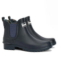 The Barbour Wilton Navy Chelsea Wellingtons Womens Rainboot features dark blue ankle height, chunky soles, tartan lining, side panels, pull tabs, and the Barbour logo on the front.