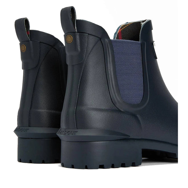 A close-up of Barbour Wilton Navy Chelsea Wellingtons Womens Rainboot shows two boots with tartan lining, side panels, pull tabs, and textured soles, highlighting the back and side details., 190375411744, 190375411867, 190375412055, 190375412123, 190375412222, 51392