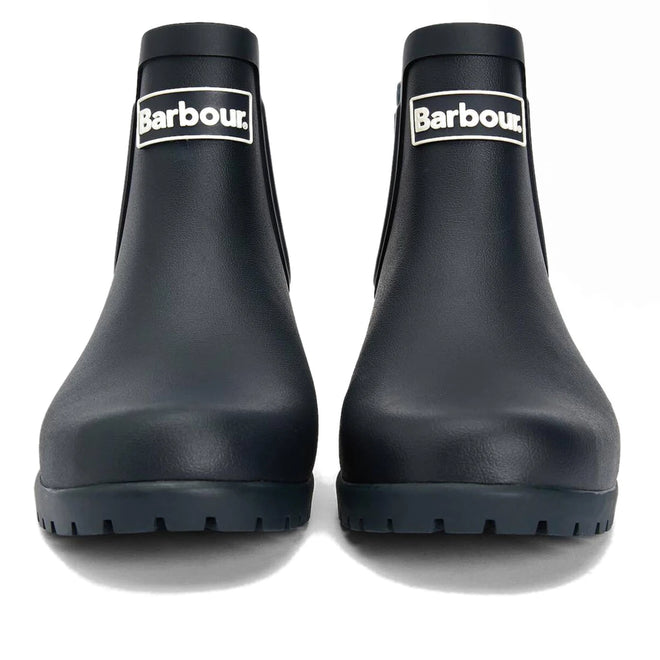 A pair of Barbour Wilton Navy Chelsea Wellingtons women's rain boots with chunky soles, shown from the front. These navy ankle boots feature a white Barbour logo patch on each shaft., 190375411744, 190375411867, 190375412055, 190375412123, 190375412222, 51392
