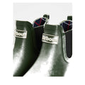Close-up of glossy Barbour Wilton Olive Chelsea Wellingtons Women's Rainboot, featuring a silver Barbour logo plate, black elastic side panels, and a hint of Barbour tartan lining visible inside., 190375411737, 190375411898, 190375411973, 190375412116, 190375412192, 190375412321