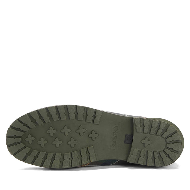 The image shows the green rubber sole of the Barbour Wilton Classic Tartan Chelsea Wellingtons Women's Rainboot, featuring a rugged tread with cross-shaped grips and deep grooves. The Barbour name is embossed in the center., 194972145934, 194972146030, 194972146122, 194972146221, 194972146283, 51397