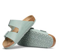 Two sage green BIRKENSTOCK Arizona Birko Flor Pure Sage Regular Width 2 Strap Sandals featuring cork-latex footbeds and patterned soles.