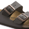 Close up view showing the solid colour dark browns straps of the Birkenstock Smooth leather slide sandal  anrrow width and the metallic looking buckles. Alos part view of the suede insole.,
4013871078616,4013871018407,4013871019466,4013871019558,4013871045779,4013871058250,4013871059127,4013871074724, , , , , 



