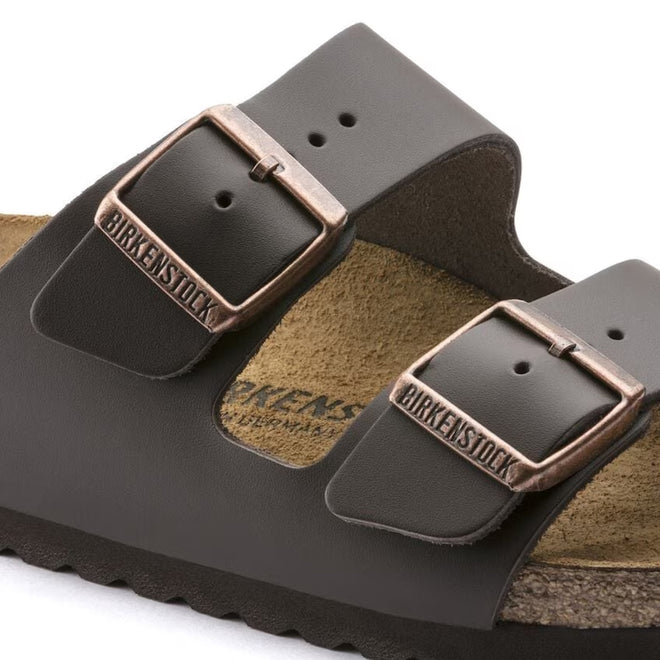 Close up view showing the solid colour dark browns straps of the Birkenstock Smooth leather slide sandal  anrrow width and the metallic looking buckles. Alos part view of the suede insole.,
4013871078616,4013871018407,4013871019466,4013871019558,4013871045779,4013871058250,4013871059127,4013871074724, , , , , 


