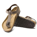 A pair of BIRKENSTOCK Kairo Womens Birkibuc Mocha Brown sandals (regular width), one upright showing the cork-latex footbed, the other on its side showing the black textured sole. Features a T-strap, adjustable ankle strap, and soft BirkiBuc upper.