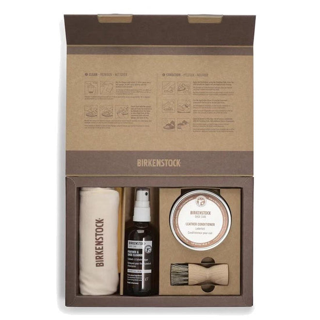 Birkenstock shoe care kit with towel, spray, brush, and cream in a cardboard box.