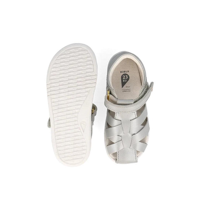The Bobux Iwalk IW Tropicana II Metallic Silver Sandal 638320 in size 23 EU features a white textured sole and a closed-toe woven quick-dry leather design with a Velcro strap—ideal summer shoes for kids., 9420075776517, 9420075781092, 9420075776210, 9420075774230, 9420075772083