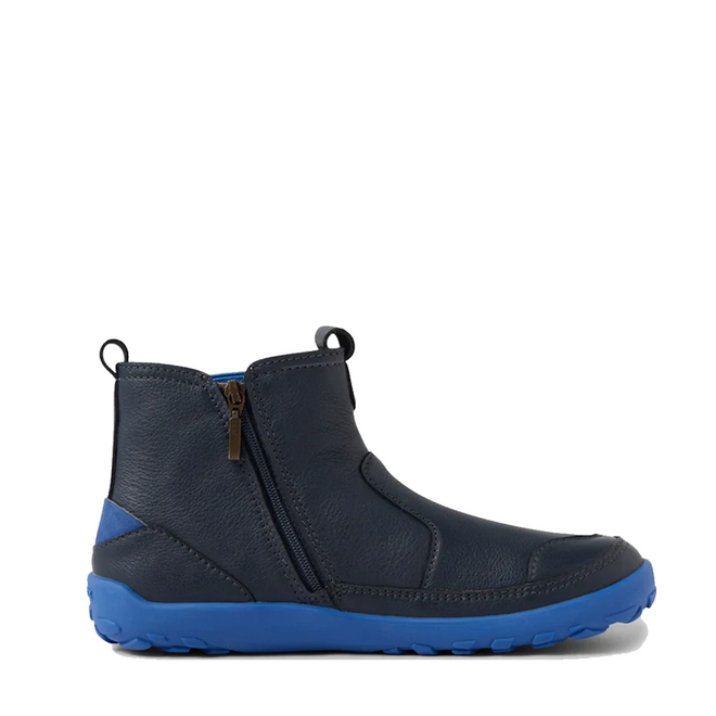 The Bobux KP Kids Plus Trail Navy Leather Boot Juniors Alpha is a navy ankle boot with a barefoot-shaped toe box, side zipper, pull tabs, and a bright blue rubber sole and heel accent with rugged tread for sporty, casual style., 9420068563704, 9420068563711, 9420068563728, 9420068563735, 9420068563742, 9420068563759, 9420068563766