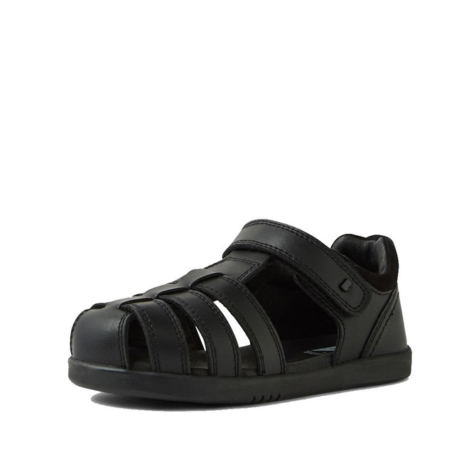 The Bobux Kid+ Roam Black School Leather Sandal Closed Toe Junior features a velcro strap, multiple side cutouts, and a flat sole—ideal as black leather school sandals for kids. Photographed on a white background.