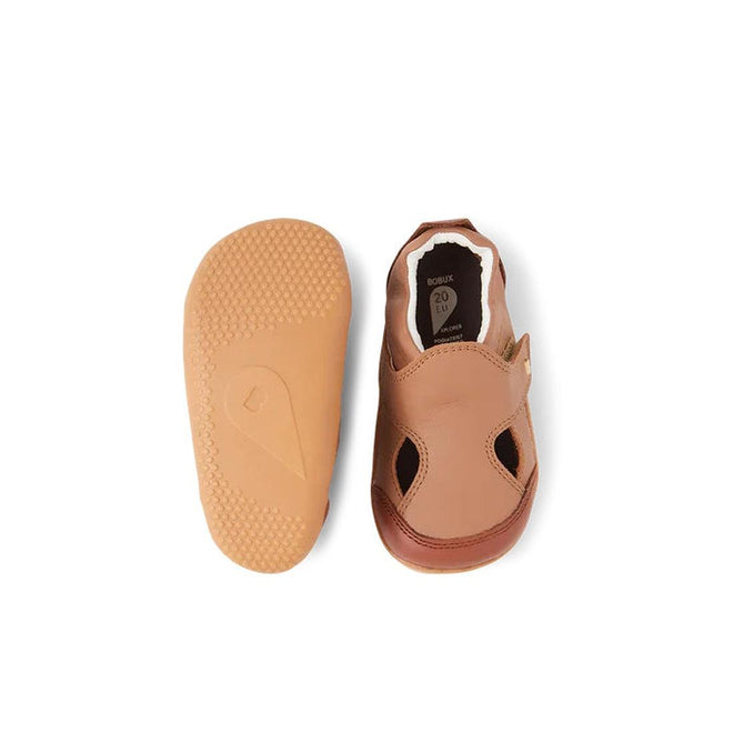 The Bobux XP Explorer Breeze First Walker Sandal Brown 502407 is shown: one upright, highlighting its open-toe design and velcro strap; the other displays a flexible, textured non-slip sole—ideal for toddlers’ first steps., 9420075761438, 9420075762749, 9420075762725, 9420075761766