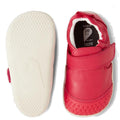 The Bobux Explorer Go Radiant Raspberry First Walker Crawler features small, bright red shoes with white rubber soles, a flexible sole bottom, upright Velcro strap, and soft leather material., 9420068568044, 9420068568051, 9420068568068, 9420068568075, 9420068568082