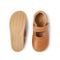 A pair of Bobux Iwalk Lola Toddlers Mary Jane Caramel Tan Leather shoes, one shown from the top with a T-bar strap, the other from below displaying the flexible, textured sole for comfort and grip., 9420068549531, 9420068549548, 9420068549555, 9420068549562, 9420068549579