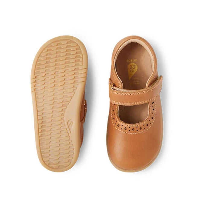 A pair of Bobux Iwalk Lola Toddlers Mary Jane Caramel Tan Leather shoes, one shown from the top with a T-bar strap, the other from below displaying the flexible, textured sole for comfort and grip., 9420068549531, 9420068549548, 9420068549555, 9420068549562, 9420068549579