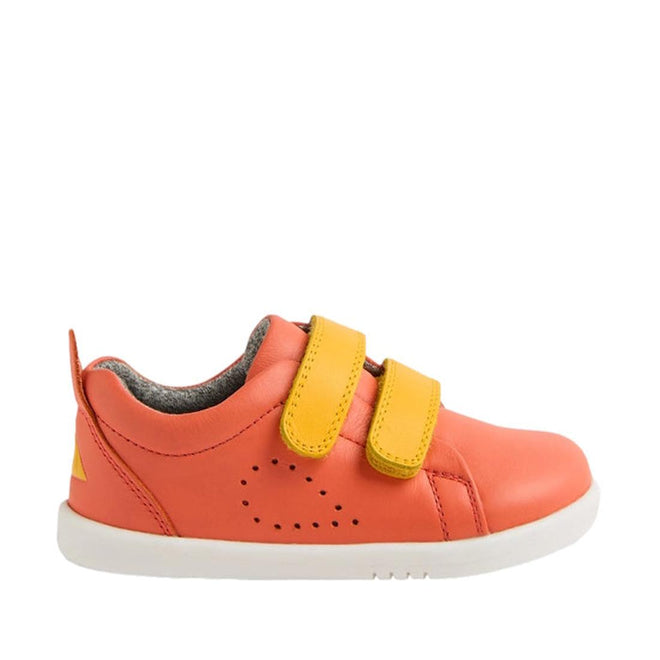 The Bobux Iwalk Grass Court Sneaker Nasturtium Orange 640220 is a unisex kids’ velcro shoe in coral leather, with two yellow straps, side ventilation holes, gray lining, and a white rubber sole—perfect for comfortable everyday wear., 46605, 46606, 46607, 46608, 46609