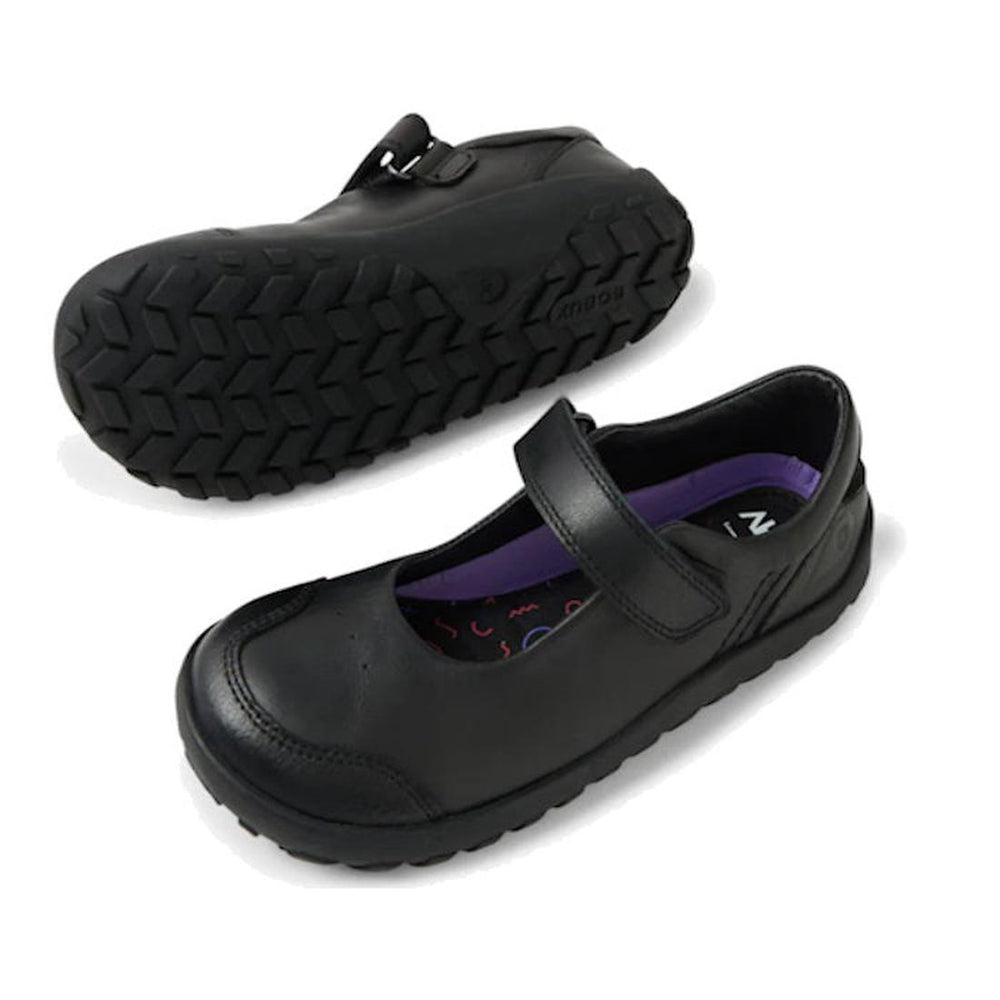 The Bobux Kid+ Hula Alpha Black School Leather Mary Jane Shoe features durable black leather, a single strap, and rugged rubber soles. One is shown side-on; the other displays the sturdy tread on the bottom.