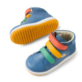 The Bobux IW Iwalk Gamepoint Leather Boot in Coronet Blue is a children's sneaker featuring yellow soles and velcro straps in red, yellow, and green. One shoe stands upright while the other is tilted to display its anti-slip rubber outsole., 9420074815170, 9420074815187, 9420074815194, 9420074815200