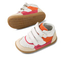 The Bobux IW Iwalk Harley Leather Boots Radiant Raspberry are kids' high-top boots with white, orange, and pink panels, beige toe caps and heels, tan rubber soles, and adjustable straps. One toddler boot stands upright; the other lies on its side., 9420074833419, 9420074833426, 9420074833433, 9420074833440