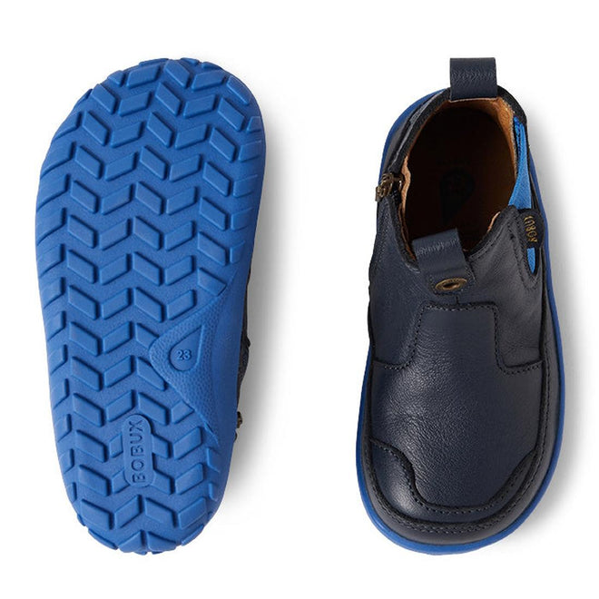 Two views of the Bobux IW Iwalk Trail Leather Boot Navy Alpha: The left shows the zigzag tread bright blue zero drop sole, while the right highlights the barefoot-shaped toe box, zip closure, and pull tab., 9420068563568, 9420068563575, 9420068563582, 9420068563599