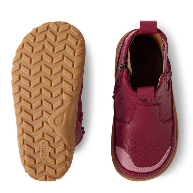 A pair of Bobux IW Iwalk Trail Leather Boot Beaujolias Purple Alpha kids' boots—one shows the textured tan rubber sole with size "23," the other highlights the upper, side zipper, and a barefoot-shaped toe box for comfort., 9420068563667, 9420068563674, 9420068563681, 9420068563698
