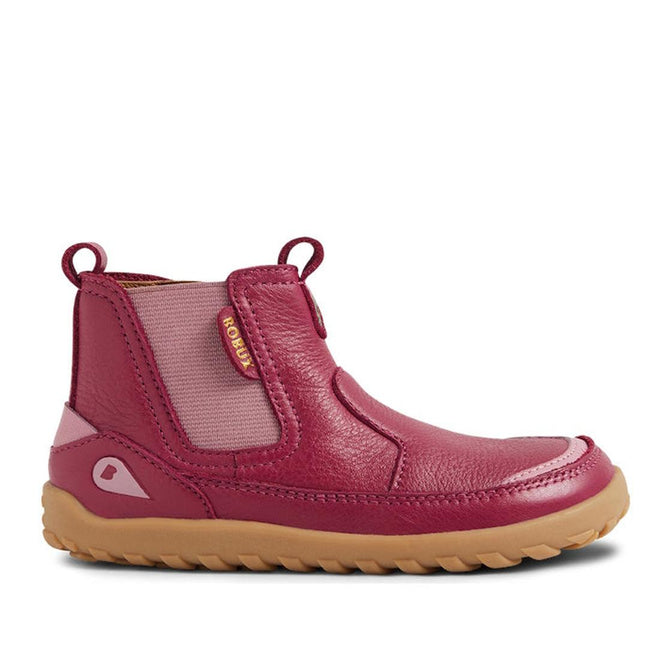 The Bobux IW Iwalk Trail Leather Boot Beaujolias Purple Alpha is an ankle-high kids' leather boot in pink and maroon, featuring elastic side panels, a back loop, tan rubber sole, textured finish, barefoot-shaped toe-box, and a BOBUX tag., 9420068563667, 9420068563674, 9420068563681, 9420068563698