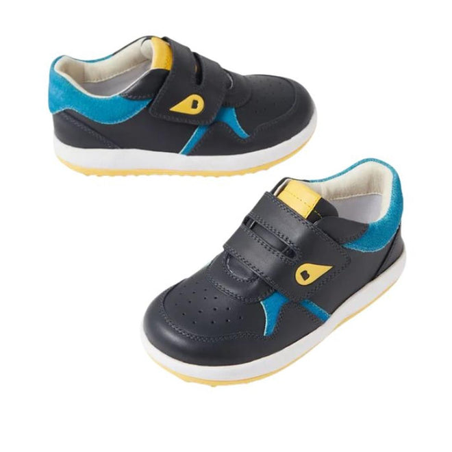 The Bobux IW Iwalk Baseline Leather Mid Sneaker in Navy features blue suede accents, yellow details, and white soles. Designed for toddlers, these kids' sneakers have hook-and-loop straps and perforated toes for easy wear and breathability., 9420074818560, 9420074818577, 9420074818584, 9420074818591