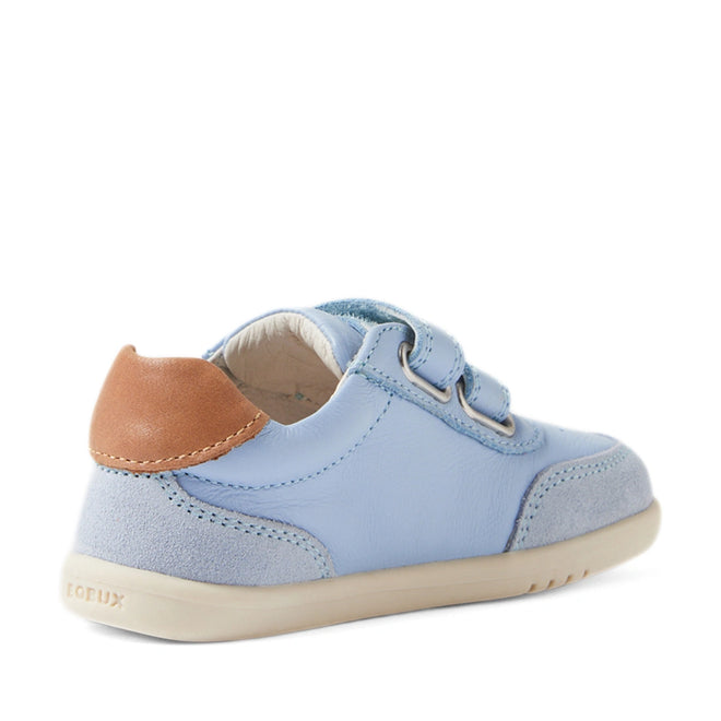 The Bobux IW Iwalk Toddlers Champ Leather Sneaker in Skyway Blue is displayed at an angle from the back, featuring light blue leather with suede and leather accents, a brown heel patch, hook and loop straps, and a light rubber sole., 9420074856753, 9420074856760, 9420074856777, 9420074856784, 9420074856791