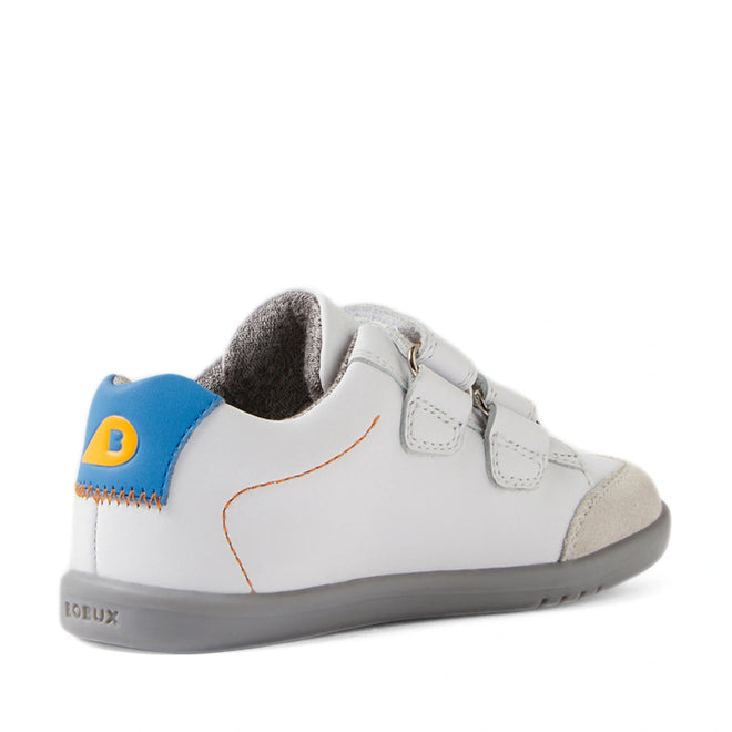 The Bobux IW Iwalk Blaze Toddlers Leather Sneaker in White Orange is a kids’ white sneaker designed for toddlers, crafted with quick-drying leather, a gray sole, blue and yellow heel detail, suede toe cap, orange stitching, and two hook-and-loop straps—shown from the back side angle., 9420074851918, 9420074851925, 9420074851932, 9420074851949, 9420074851956