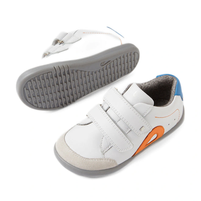 Bobux IW Iwalk Blaze Toddlers Leather Sneaker White Orange: These toddler sneakers feature premium white leather, gray soles, blue heel accents, and a striking orange side detail. Designed for easy on and off with two hook-and-loop Velcro straps, these stylish kids’ shoes combine comfort and functionality—one sneaker is showcased upright while the other displays its textured sole., 9420074851918, 9420074851925, 9420074851932, 9420074851949, 9420074851956