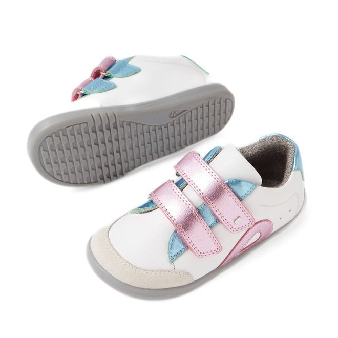 Two Bobux IW Iwalk Blaze Toddlers Leather Sneakers in white leather feature gray soles, pink metallic Velcro straps, and blue metallic accents. One shoe stands upright while the other rests on its side to display the sole—ideal as an everyday sneaker for toddlers., 9420074851987, 9420074851994, 9420074852007, 9420074852014, 9420074852021