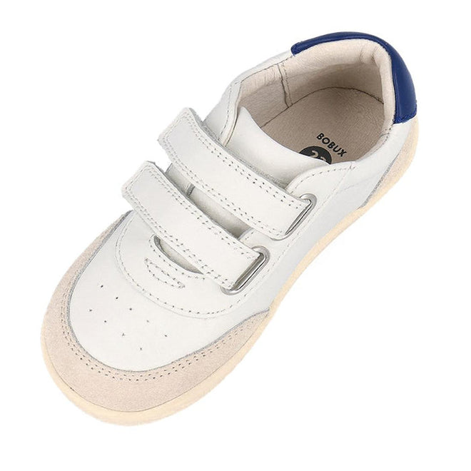 The Bobux Kids IWalk IW Champ Sneaker Chalk White Blue 650501 features two Velcro straps, a beige suede toe, and a blue heel accent—perfect unisex sneakers for everyday wear., 9420075767843, 9420075781443, 9420075780316, 9420075781368, 9420075780460