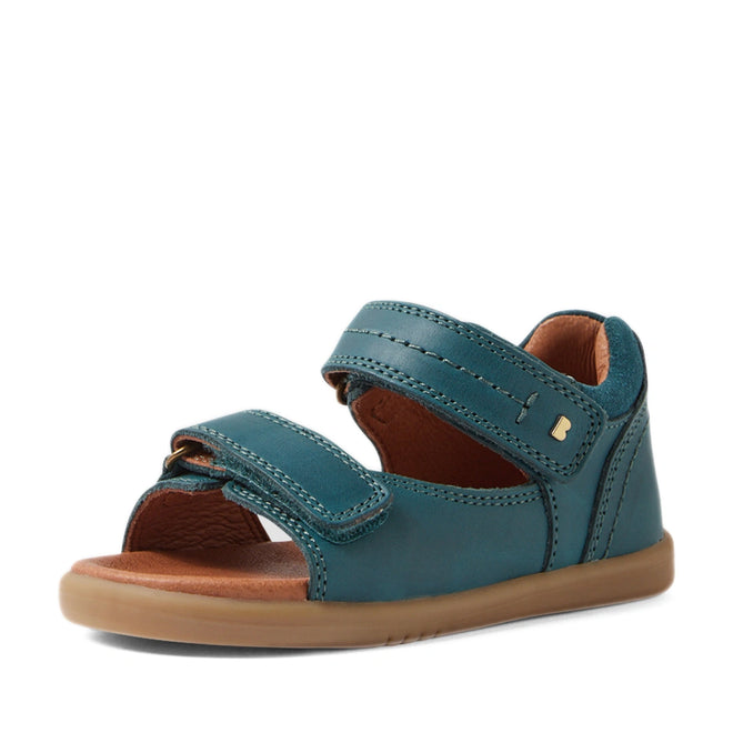 The Bobux IWalk Driftwood Sandal in Mediterranean Green is a children’s sandal featuring two adjustable Velcro straps, an open toe for breathability, a brown cushioned sole, and a closed heel—making it a stylish choice for toddler boys’ leather sandals—displayed on a white background., 9420074807601, 9420074807618, 9420074807625, 9420074807632, 9420074807649