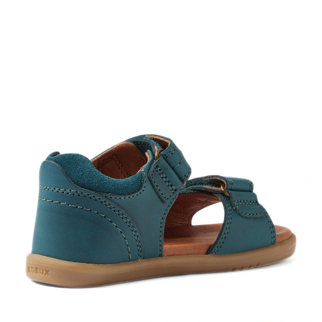 A Mediterranean green children’s sandal—Bobux IWalk Driftwood Sandal Mediterrainean Green Open Toe—inspired by the classic Driftwood design, features a closed heel, open toe style, and adjustable straps. Viewed from the back side angle, these toddler boys’ leather sandals are complemented by a light brown sole for a timeless look., 9420074807601, 9420074807618, 9420074807625, 9420074807632, 9420074807649