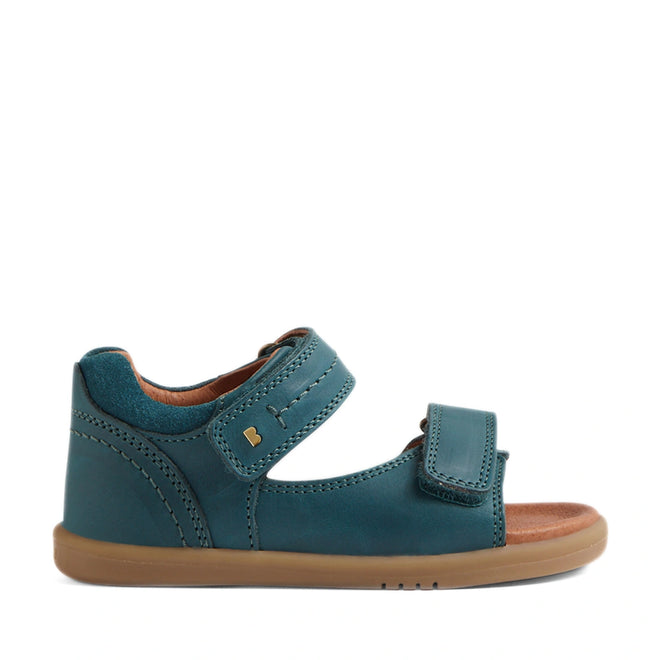 The Bobux IWalk Driftwood Sandal in Mediterrainean Green is a toddler boys’ open-toe leather sandal featuring two adjustable Velcro straps, a tan lining, and a light brown rubber sole. Shown in side profile against a white background, this design takes inspiration from the classic Bobux Driftwood style., 9420074807601, 9420074807618, 9420074807625, 9420074807632, 9420074807649