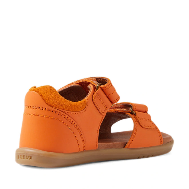 The Bobux IWalk Driftwood Sandal in Orange Peel is an open-toed leather sandal for toddler boys, featuring a closed heel, adjustable straps, and a tan rubber sole. Inspired by the classic Driftwood style, this sandal is shown from a rear side angle on a plain white background., 9420074807656, 9420074807663, 9420074807670, 9420074807687, 9420074807694