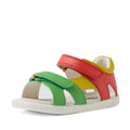 The Bobux IWalk Dune Toddlers Sandal in Grenadine Red features green, yellow, and red adjustable straps, an open toe design, a white sole, and a Velcro closure—making it the perfect adventure-ready sandal for little explorers., 9420074855091, 9420074855107, 9420074855114, 9420074855121, 9420074855138