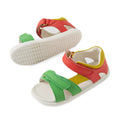 Two adventure-ready Bobux IWalk Dune Toddlers Sandals in Grenadine Red, designed with white soles, green and red adjustable straps, yellow accents, soft leather uppers, Velcro closures, and open toes. Displayed on a plain white background., 9420074855091, 9420074855107, 9420074855114, 9420074855121, 9420074855138