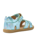 The Bobux IWalk Flora Toddlers Sandal Jelly Mint Metallic Blue Open Toe showcases a playful light blue floral pattern, crafted from premium leather with an open toe and secure Velcro strap. Viewed from the back and side, these stylish sandals highlight detailed stitching and design, set on a durable tan rubber sole—perfect for active children on sunny days.