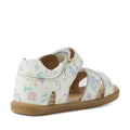 The Bobux IWalk Flora Toddlers Sandal in White Floral features pastel floral patterns, an open toe design, and a secure ankle strap. Crafted from soft and flexible leather with a light brown sole, the sandal is displayed at an angle to showcase both the back and side.