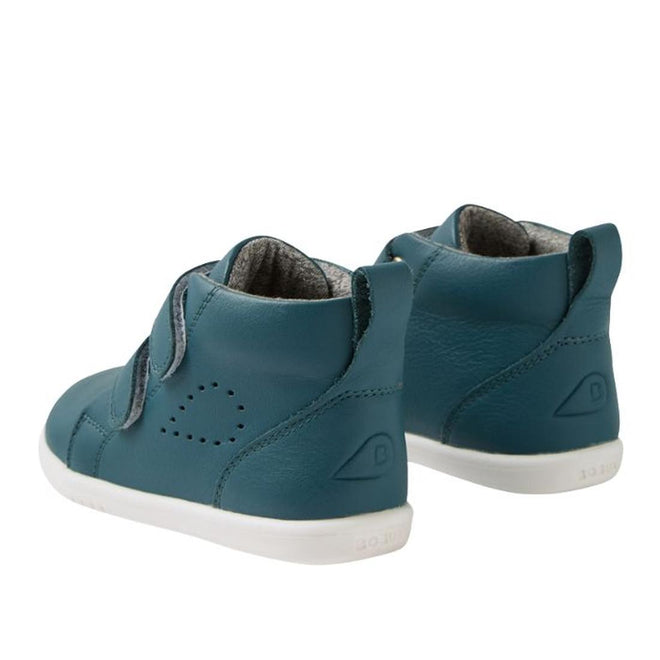 The Bobux IW Iwalk Grass Court Hi Leather Boot in Mediterranean Green features white soles, side perforations, and adjustable Velcro straps. The kids’ shoes are shown facing away and slightly to the side on a white background., 9420074856814, 9420074856821, 9420074856838, 9420074856845
