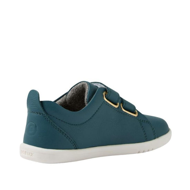 The Bobux IW Iwalk Grass Court Leather Sneaker in Mediterranean Green features a premium leather upper, white sole, dual velcro straps, gold eyelets, visible stitching, and gray interior lining. Shown from the back left side., 9420074806734, 9420074806741, 9420074806758, 9420074806765, 9420074806772