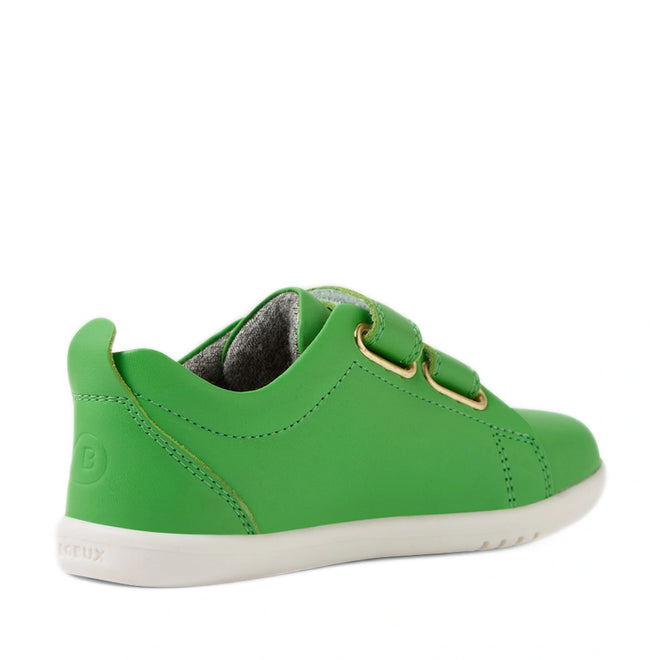 A back-left angled view of the Bobux Iwalk Toddlers Grass Court Retro Green Leather Trainer, featuring a green leather upper, white sole, gold eyelets, and two hook-and-loop straps—ideal for fans of the iconic Grass Court style., 9420074806789, 9420074806796, 9420074806802, 9420074806819, 9420074806826