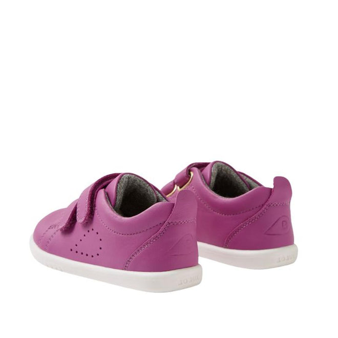 The Bobux IW Iwalk Grass Court Leather Sneaker in Cattleya Orchid Purple features white soles, double Velcro straps, and side perforations for toddlers, shown at an angle displaying both back and side views., 9420074806987, 9420074806994, 9420074807007, 9420074807014, 9420074807021