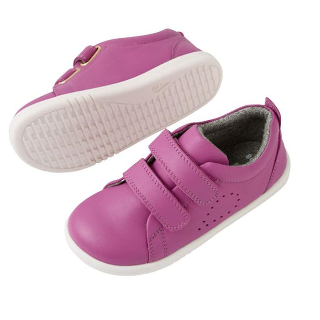 The Bobux IW Iwalk Grass Court Leather Sneaker in Cattleya Orchid Purple is a children's trainer with white soles, double strap closure, and side perforations for ventilation. One shoe is shown from the side, the other from the bottom., 9420074806987, 9420074806994, 9420074807007, 9420074807014, 9420074807021